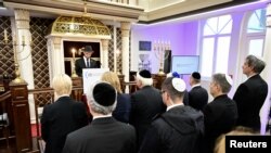 FILE - German President Frank-Walter Steinmeier, Chancellor Olaf Scholz and other government officials stand during a prayer by Rabbi Zsolt Balla for the 85th anniversary of Kristallnacht, in the Beth Zion Synagogue in Berlin, Germany, on November 9, 2023