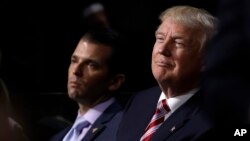 FILE - Republican Presidential Candidate Donald Trump and his son Donald Trump Jr.attend the Republican National Convention in Cleveland, July 20, 2016.