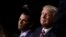 FILE - Republican Presidential Candidate Donald Trump and his son Donald Trump Jr., watch as Eric Trump addresses the delegates during the third day session of the Republican National Convention in Cleveland, July 20, 2016.