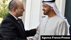 A photo released by the Israeli Press Office shows Abu Dhabi's Crown Prince Sheikh Mohammed bin Zayed Al-Nahyan, right, receiving Israeli Prime Minister Naftali Bennett following his arrival in the Emirati capital, on Dec. 13, 2021. 
