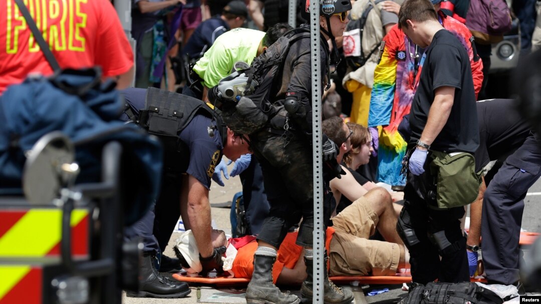 Rescue workers assist people who were injured when a car drove through a group of counter protestors at the "Unite the Right" rally Charlottesville, Virginia, Aug. 12, 2017. 