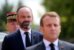 FILE - French President Emmanuel Macron and French Prime Minister Edouard Philippe attend the traditional annual ceremony at the Mont-Valerien, a memorial for the French who fought against the Nazis and those who were killed by the occupying forces.
