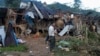 FILE - A man looks at homes destroyed by airstrikes in a refugee camp in Laiza, Myanmar, on Oct. 10, 2023. The attack killed at least 29 people, including children. Resistance leaders have blamed the ruling junta for the strikes, although the military denies involvement.