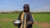 FILE - A farmer sprinkles fertilizer onto crops at a field on Tuti Island, Khartoum, Sudan, Feb. 12, 2020. The island in the middle of the Nile serves as a microcosm for the devastation unleashed by a war that began in April 2023.