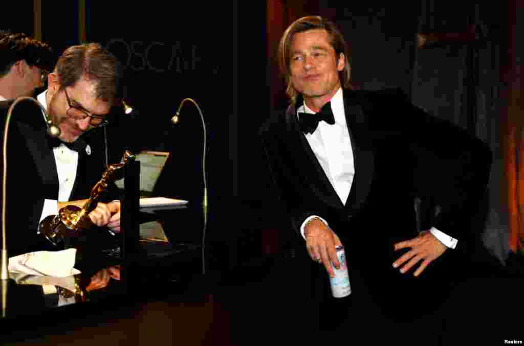Best Supporting Actor Brad Pitt waits for his Oscar statue to be engraved at the Governors Ball following the 92nd Academy Awards in Los Angeles, California, Feb. 9, 2020.