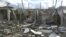 Buildings damaged by what activists said were missiles fired by a Syrian Air Force fighter jet operated by forces loyal to Syrian President Bashar al-Assad are seen at Houla, near Homs December 6, 2012. 