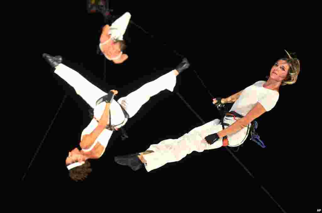 Performers from France&#39;s Compagnie Retouramount are suspended during during the annual Night Festival at the Singapore Museum in Singapore.