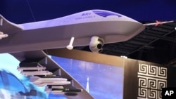FILE - A model of the Wing Loong II weaponized drone is displayed at a stand for the China National Aero-Technology Import & Export Corp., at a military drone expo in Abu Dhabi, United Arab Emirates, Feb. 25, 2018.
