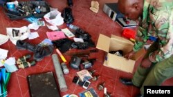 Hand grenades and other items are displayed by police after an early morning raid at a mosque in the coastal town of Mombasa, Nov. 17, 2014. 