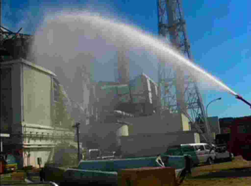 A fire truck sprays water at No. 3 reactor of the Fukushima Daiichi nuclear power plant after the 2011 earthquake and tsunami damaged the facility. (Mandatory Credit REUTERS/Self Defense Force Nuclear Biological Chemical Weapon Defense Unit via Reuters TV