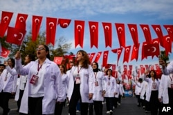 Medicine university students take part in a parade during celebrations marking the 100th anniversary of the creation of the modern secular Turkish Republic, in Istanbul, Turkey on October 29, 2023. (AP Photo/Emrah Gurel)