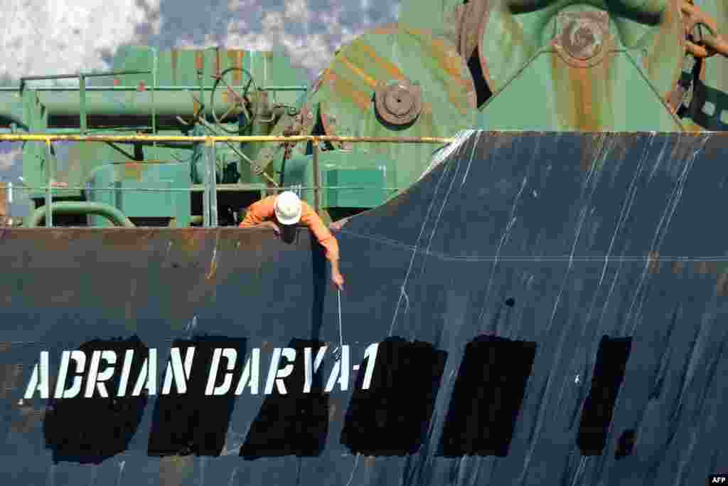 A crew member checks the new name of Iranian oil tanker Adrian Darya, formerly known as Grace 1, off the coast of Gibraltar. Gibraltar rejected a U.S. demand to seize the tanker at the center of a diplomatic dispute.