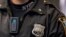 FILE - A police body camera is seen on an officer during a news conference on the pilot program of body cameras in the Queens borough of New York