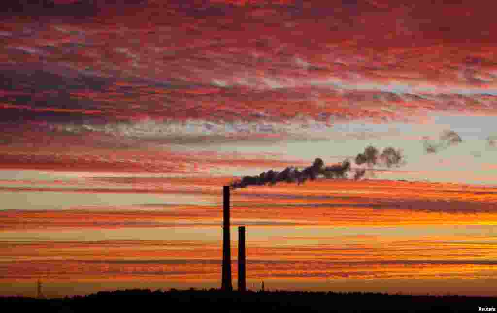 Smoke rises from the chimney stalk of a gas-fired power station after sunset on the outskirts of Minsk, Belarus.