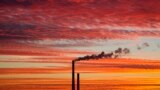 Smoke rises from the chimney stalk of a gas-fired power station after sunset on the outskirts of Minsk, Belarus.