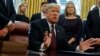 FILE - President Donald Trump answers a reporters question about the investigation of special counsel Robert Mueller during a signing ceremony of the "Cybersecurity and Infrastructure Security Agency Act," in the Oval Office of the White House, Nov. 16, 2018.