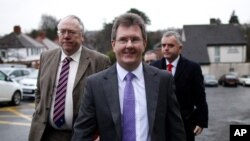 Democratic Unionist Party members Jeffrey Donaldson (center) and Jonathan Bell (right) along with Mervyn Gibson (left) Senior member of the Orange Order arrive for the final day of talks at the Stormont Hotel, Belfast, Northern Ireland, Dec. 30, 2013. 