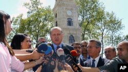 Turkey's President Recep Tayyip Erdogan, center, talks to members of the media after attending Friday prayers in Istanbul, Aug. 18, 2017.