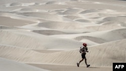 A competitor takes part in the fifth stage during the first edition of the Marathon des Sables Peru between Barloveto and Mendieta in the Ica desert on December 3, 2017. 