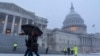 People walk through snow at the Capitol, Feb. 11, 2025, during a snowstorm in Washington. 