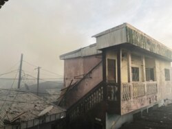 FILE - Smoke rises after a fire tore through an overcrowded New-Bell central prison in the port city of Douala, Cameroon, May 28, 2020.