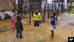 Children jump rope at the Tudor Shaft squatter settlement near Randfontein, west of Johannesburg, South Africa, January 26, 2011.