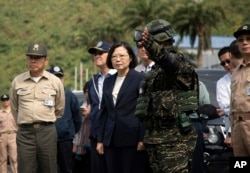 FILE - Taiwan's President Tsai Ing-wen, center, inspects at Su'ao naval station during a navy exercise in the northeastern port of Su'ao in Yilan County, Taiwan, Apr. 13, 2018.