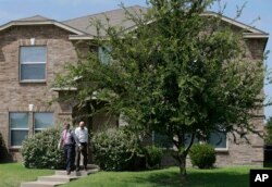 Investigators leave the home of Micah Xavier Johnson in the Dallas suburb of Mesquite, Texas, July 8, 2016.