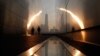 A man walks through the 9/11 Empty Sky memorial at sunrise across from New York's Lower Manhattan and One World Trade Center in Liberty State Park in Jersey City, New Jersey, September 11, 2013. Americans will commemorate the 12th anniversary of the Septe