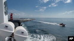 SpaceX support teams are deployed on fast boats from the SpaceX GO Navigator recovery ship ahead of the splashdown of the SpaceX capsule carrying two astronauts, Aug. 2, 2020, in the Gulf of Mexico off the coast of Pensacola, Florida.