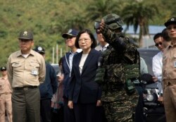 FILE - Taiwan's President Tsai Ing-wen, center, inspects at Su'ao naval station during a navy exercise in the northeastern port of Su'ao in Yilan County, Taiwan, April 13, 2018.