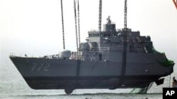 Salvaging the bow section of the South Korean naval ship Cheonan. Evidence indicates a torpedo launched from a small North Korean submarine hit the Cheonan on March 26, 2010, killing 46 sailors. (AP Photo/Yonhap, Choi Jae-ku, File)