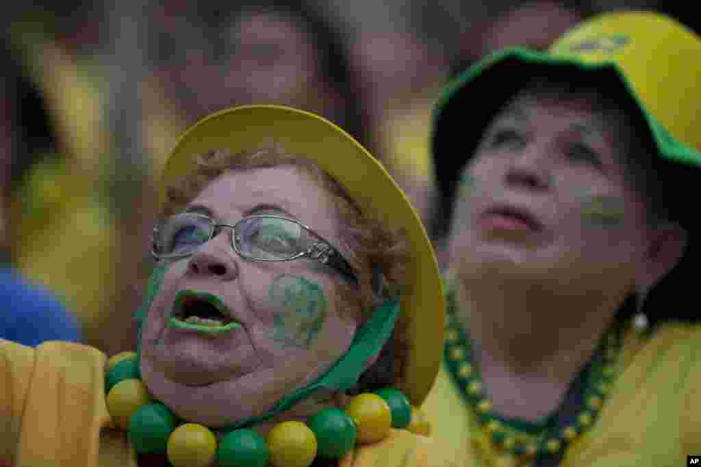 A fan of the Brazilian national soccer team watches the World Cup match against Mexico at the FIFA Fan Fest in Sao Paulo, Brazil, June 17, 2014.