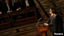 Blind Chinese activist Chen Guangcheng (2nd R), standing with his wife Yuan Weijing, delivers remarks at the National Cathedral in Washington, January 30, 2013. 