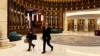 Kirill Dmitriev, the head of the Russian Direct Investment Fund, right, and Maria Medvedeva, the deputy CEO for external communication for the fund, walk across the Ritz Carlton hotel in Riyadh, Saudi Arabia, Feb. 18, 2025.