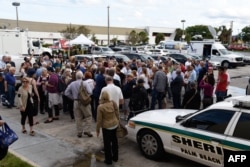 Volunteers gather outside to go over the manual counting process before the start of the count in West Palm Beach, Florida, Nov. 15, 2018.