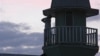 Member of Islamic sect calls for evening prayer from atop the house where followers lived in seclusion, Kazan, Russia, Aug. 9, 2012.