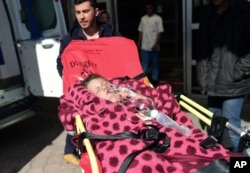 Turkish medics carry a wounded Syrian child to a hospital in Kilis, Turkey, Feb. 16, 2016.