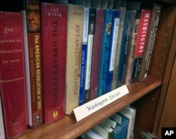 A row of books about President George Washington line a shelf at the New Hampshire Political Library at Saint Anselm College in Manchester, New Hampshire, June 9, 2017.