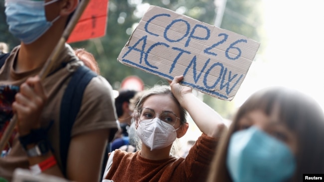 FILE - People take part in a march for climate justice while environment ministers meet ahead of Glasgow's COP26 meeting, in Milan, Italy, October 2, 2021.