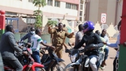 A soldier asks people to disperse outside Guillaume Ouedraogo army camp after Burkina Faso President Roch Kabore was detained at a military camp in Ouagadougou, Burkina Faso Jan. 24, 2022.