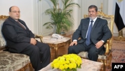 Egyptian President Mohamed Morsi (R) is seen with Prosecutor General Talaat Abdullah in a photo released by Morsi's office November 22, 2012.