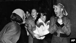 This is a vintage American horror scene. Girls scream at a "haunted mansion" in suburban Sacramento, California, when a Halloween "monster" scares them, October 30, 1979. (AP Photo/RCP)