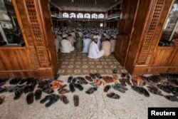 FILE - Students attend a lesson at Darul Uloom Haqqania, an Islamic seminary and alma mater of several Taliban leaders, in Akora Khattak, Khyber Pakhtunkhwa province, Sept. 14, 2013.