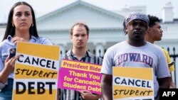 FILE - Activists gather to rally in support of cancelling student debt, in front of the White House in Washington, DC, on August 25, 2022.