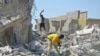 Scavengers work at the scene of a collapsed building in suburban Abuja, Nigeria, Oct. 28, 2024.