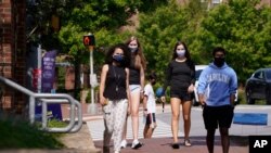 Students wear masks on campus at the University of North Carolina in Chapel Hill, N.C., Aug. 18, 2020.