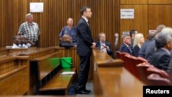 Olympic and Paralympic track star Oscar Pistorius stands in the dock at the North Gauteng High Court in Pretoria, September 11, 2014. Pistorius, the double amputee who became one of the biggest names in world athletics, faced justice on Thursday as a Sout