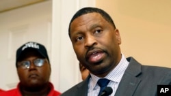 FILE - NAACP Interim president and CEO Derrick Johnson, right, speaks during a July 31, 2017 news conference in Jackson, Mississippi.