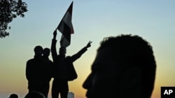 The sun sets on protesters as they demonstrate and celebrate in Tahrir Square in Cairo February 11, 2011
